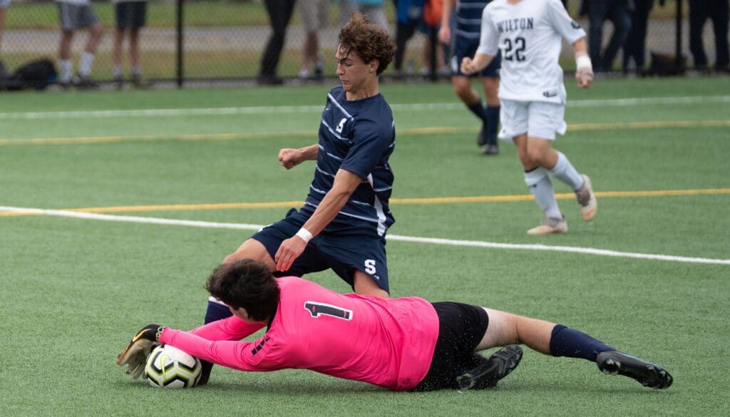 Reese Watkins’ shot is smothered by the Wilton goalkeeper. - Photo Barry Guiduli