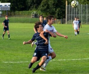 Reese Watkins has his hands full with a Danbury defender. Photo Barry Guiduli.