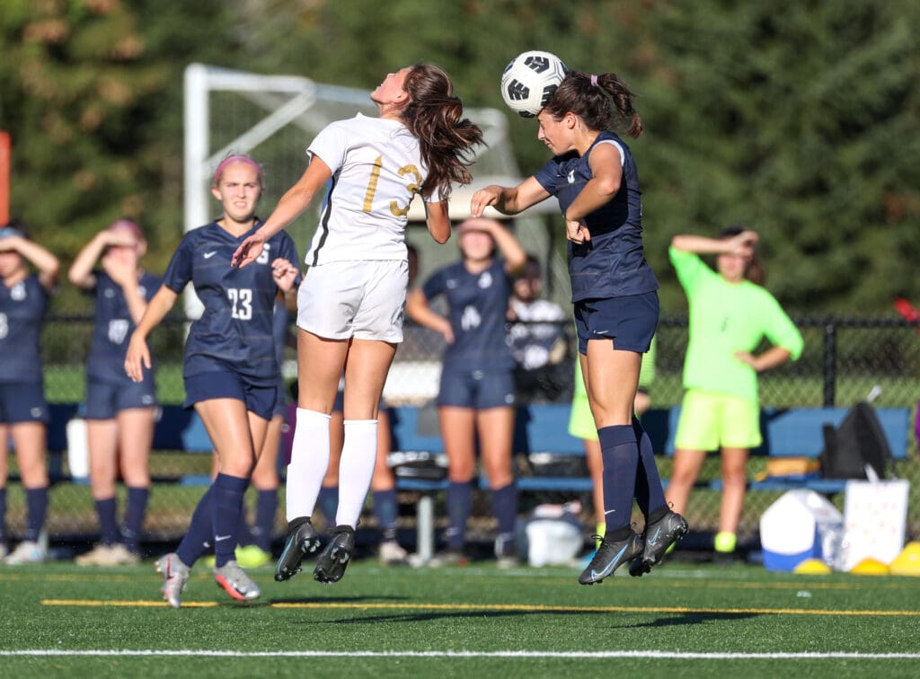 Katie Shakleford (13) watches a Talia Moskowitz header -- Photo Shelley Burger