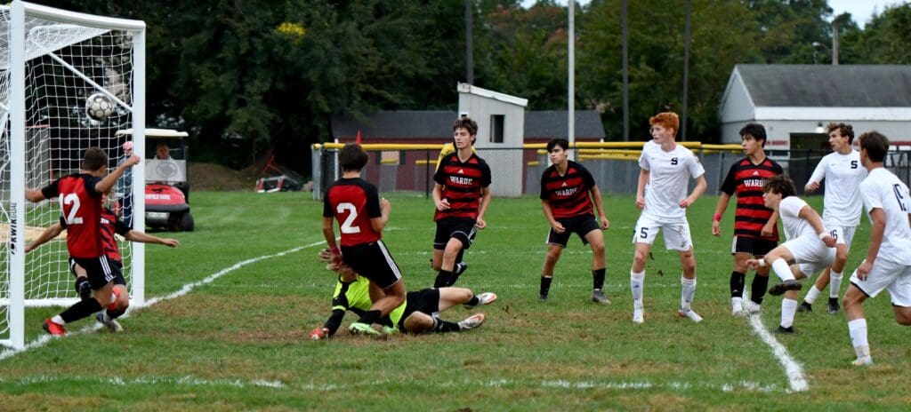 Reese Watkins (2nd from left, in white) scores the game-winner at Fairfield Warde. Dylan Hoke, Caleb Tobias and Jack Foster wait anxiously. Photo - Mark Sikorski