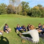 Ryan Thomas and Hunter Smith lead 5th and 6th graders in pre-game stretching.
