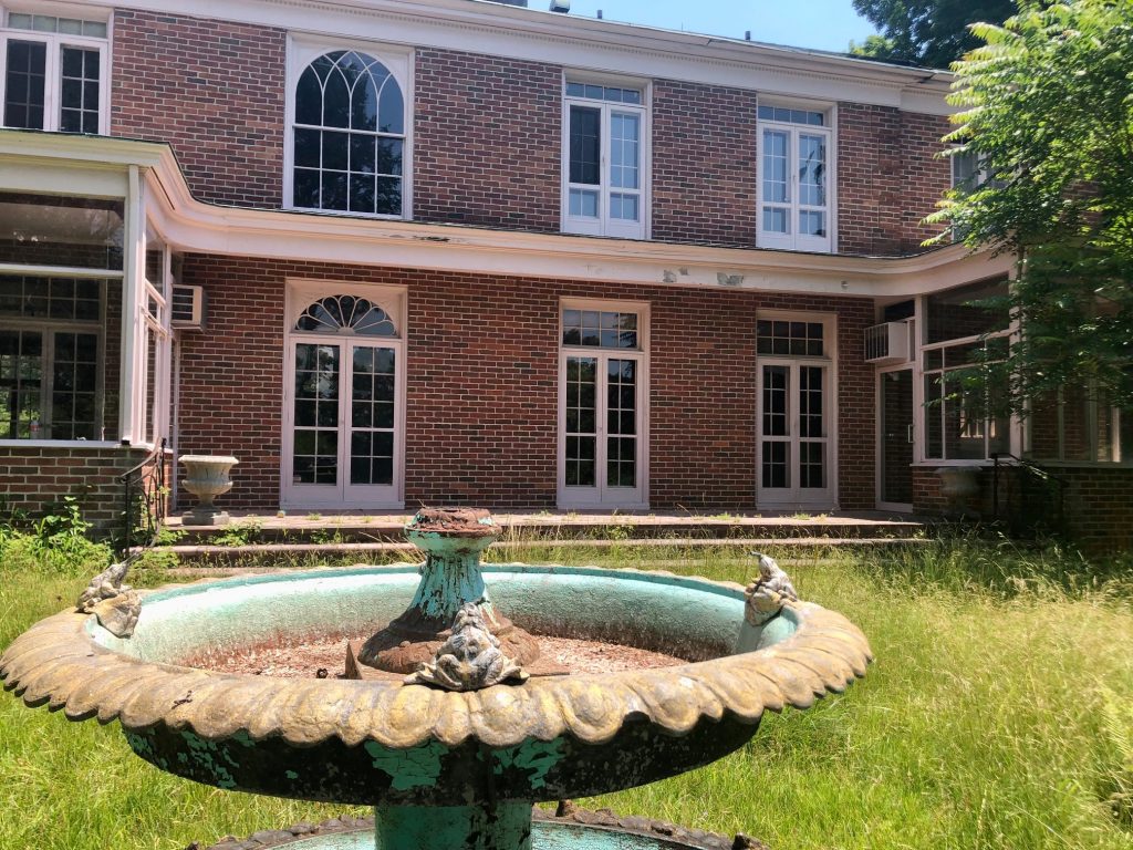 A fountain and patio at the rear of the town-owned Golden Shadows estate on the Baron's South property. / Photo by Thane Grauel.