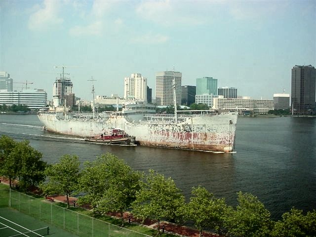 USS Saugatuck, after decades of service in three wars, being towed by tug for dismantling in Chesapeake, Va., in July 2006. / Photo by Mabel Clark.