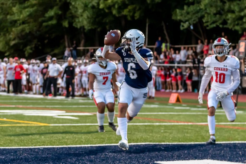 James Hillhouse scores an early touchdown to set the tone as the Staples football team rolls past visiting Conard 42-13 in the season opener, on Sept. 9. - Chris Greer photo
