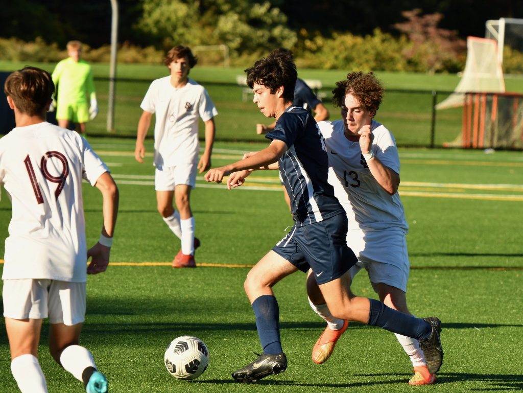 Luca Escalarte maneuvers through a pack of St. Joseph Cadets – Photo Mark Sikorski