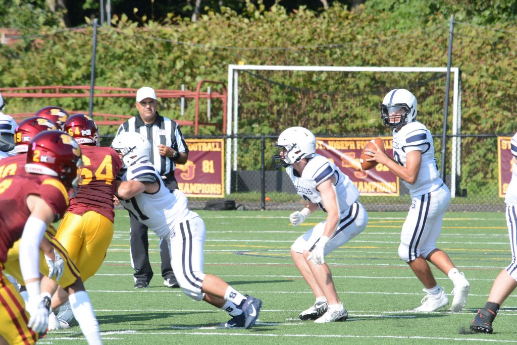 Quarterback Caleb Smith looks to complete a pass in a game at St. Joseph this fall. Smith had three passing touchdowns as well as three rushing scores in 56-7 win over Norwalk on Friday–Photo Andy Hutchison