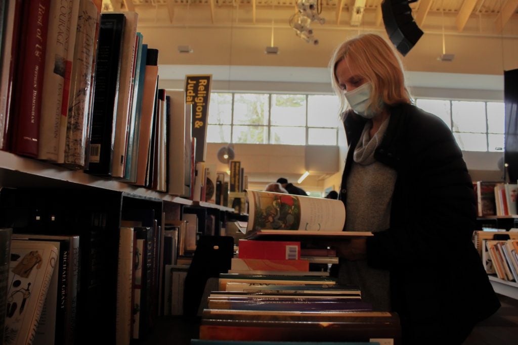 Molly Rabinowitz peruses the offerings at the Westport Library's fall book sale. / Photo by Corrina Palarino.