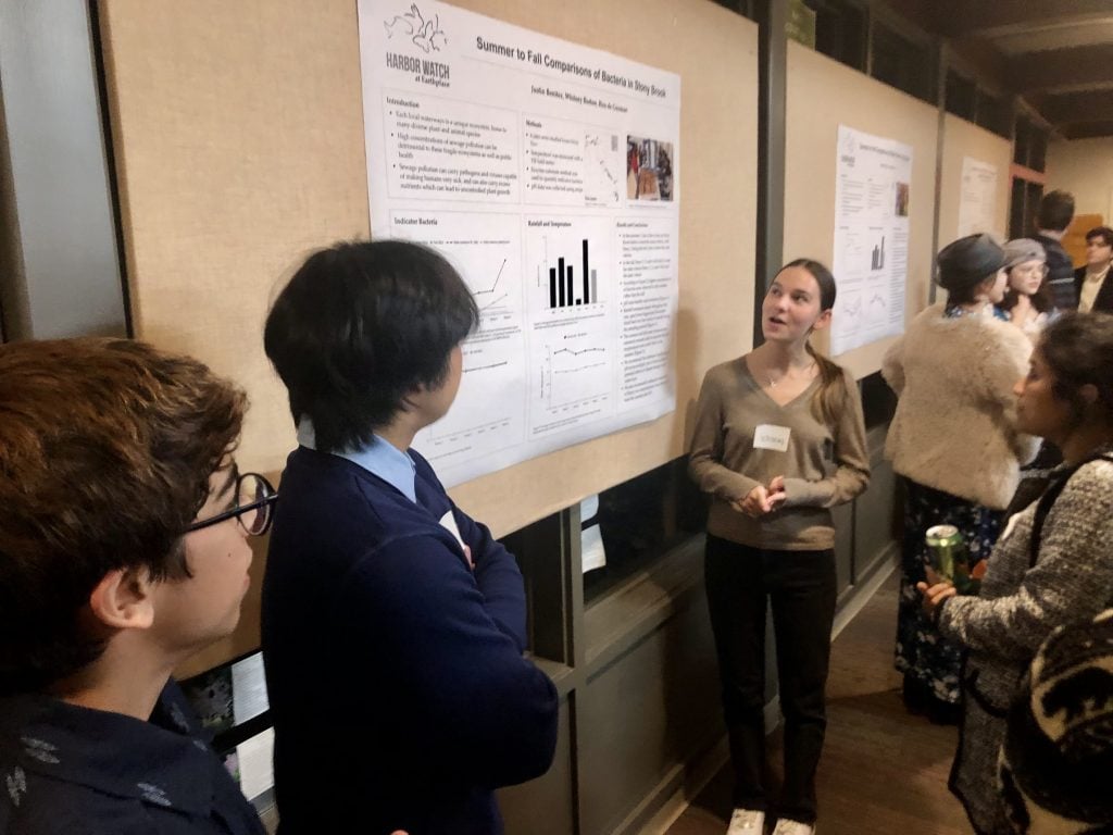 Justin Benitez, Rico de Guzman and Whitney Burton discuss bacteria counts in Stony Brook. / Photo by Thane Grauel