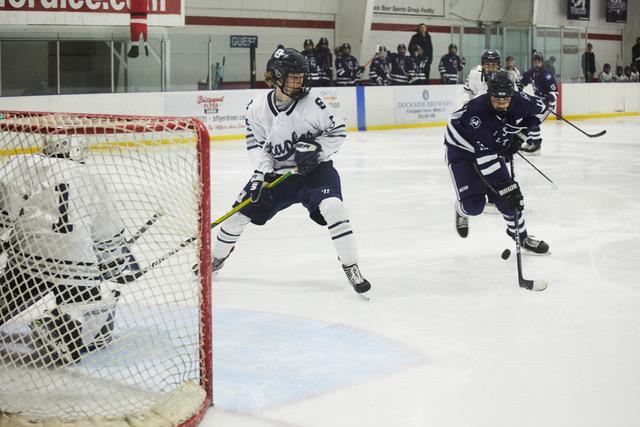 Carter Fass defends as goaltender Aaron Kail gets into position during a win over Wilton to start the season. Staples fell 6-3 to Enfield on Saturday. - Photo Videler Photography / John Videler