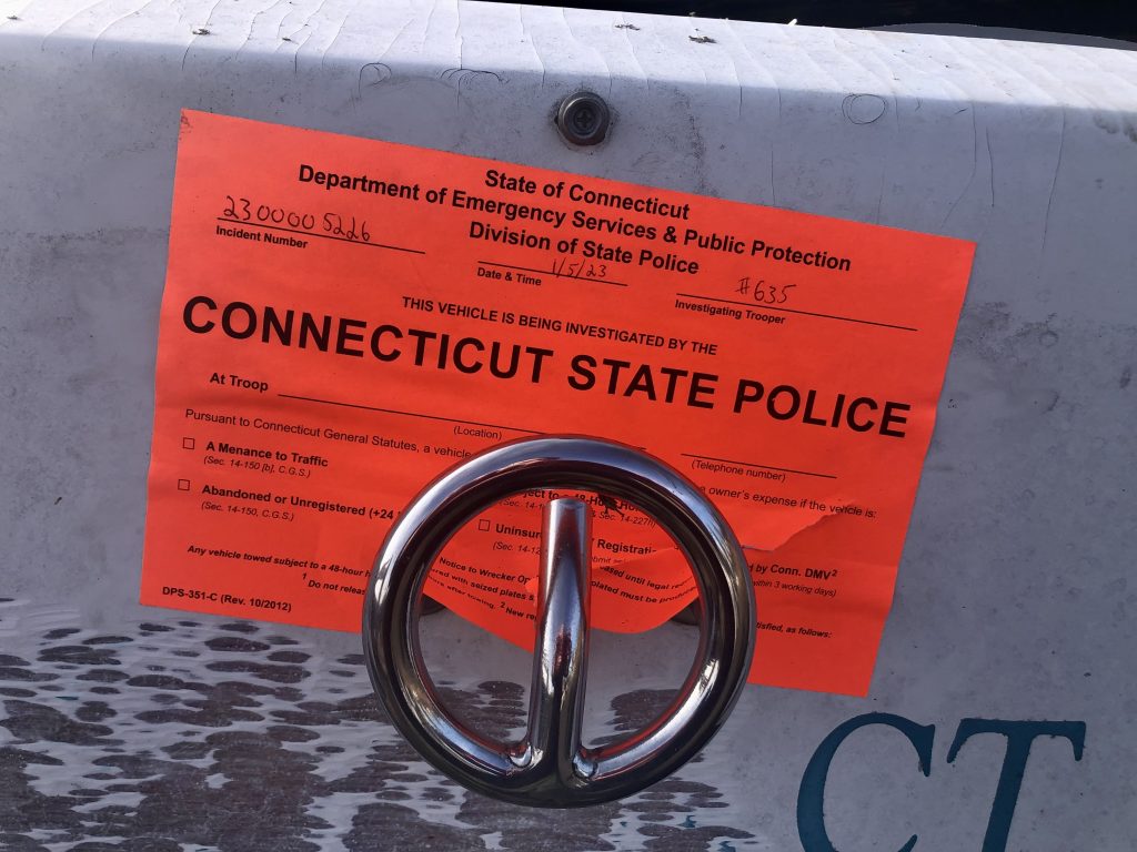 A sticker affixed to the motorboat abandoned at Exit 17. / Photo by Thane Grauel