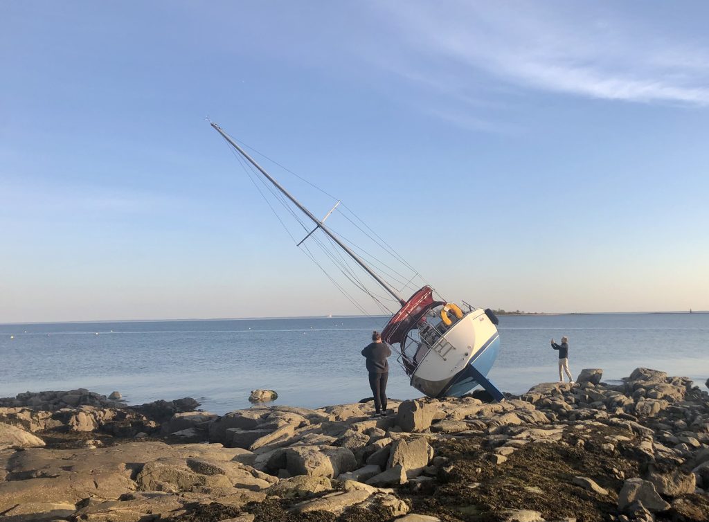 Windblown sailboat on the rocks at Compo Beach. / Photo by Thane Grauel