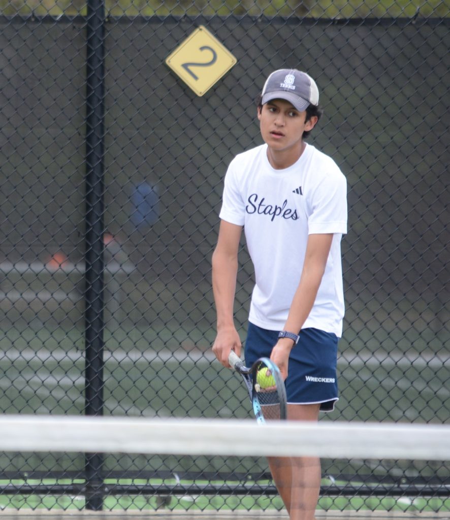 Lucas Ceballos-Cala serves the ball into play during his win at second singles. / Photo by Andy Hutchison