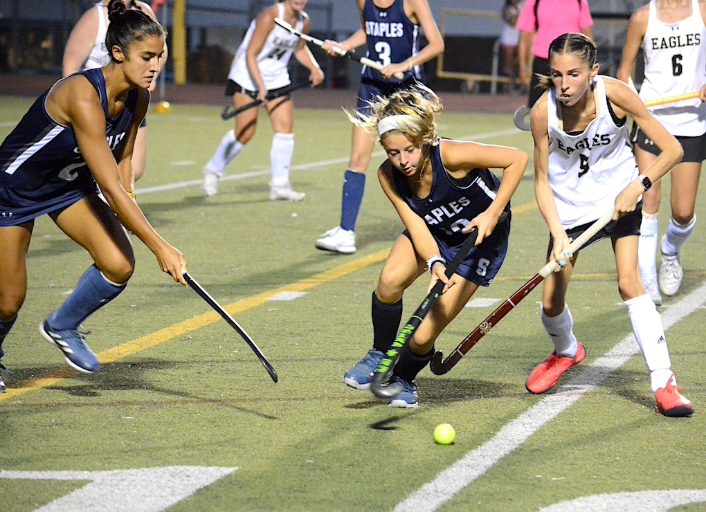 Staples’ Alex Hackett, left, and Leah Larit, center, in action earlier this fall. Both players scored in the season finale, a 2-1 overtime win at Ridgefield.