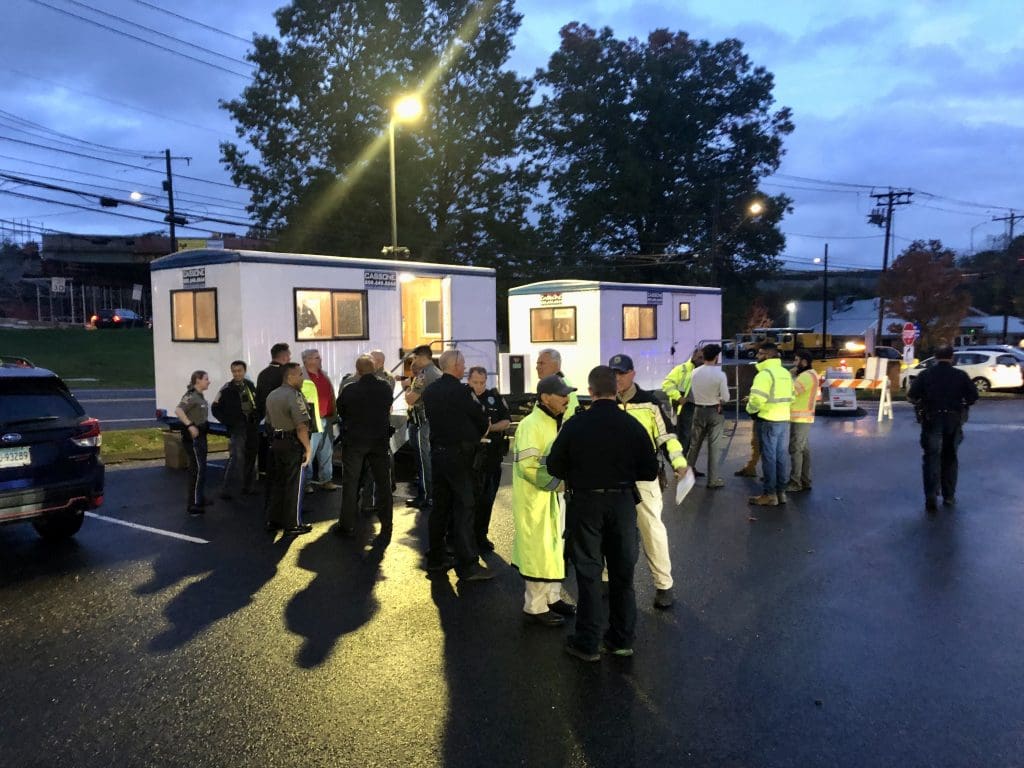 State police and officers from Norwalk and Westport gather at commuter lot 7 a couple hours before the traffic was shifted on I-95. / Photo by Thane Grauel