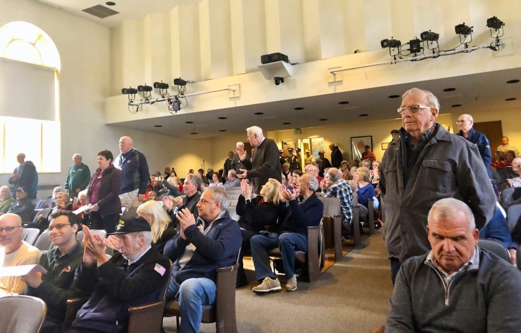 Veterans were asked to stand when the song for their branch was played in a medley.