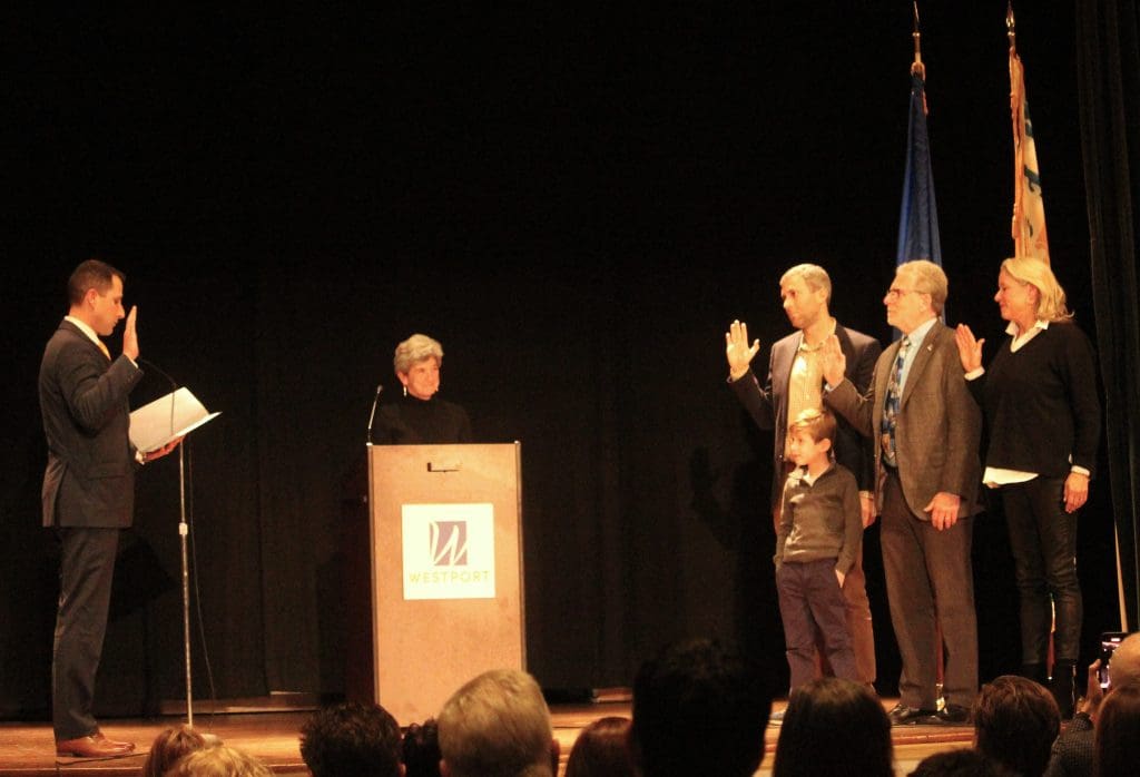 Town Clerk Jeffrey Dunkerton swears in Andrew Bloom, Matthew Mandell and Kristin Mott Purcell of District 1.