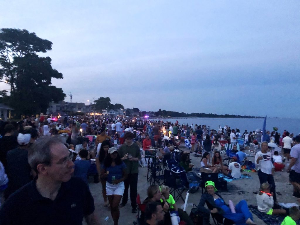 A packed Compo Beach at dusk.