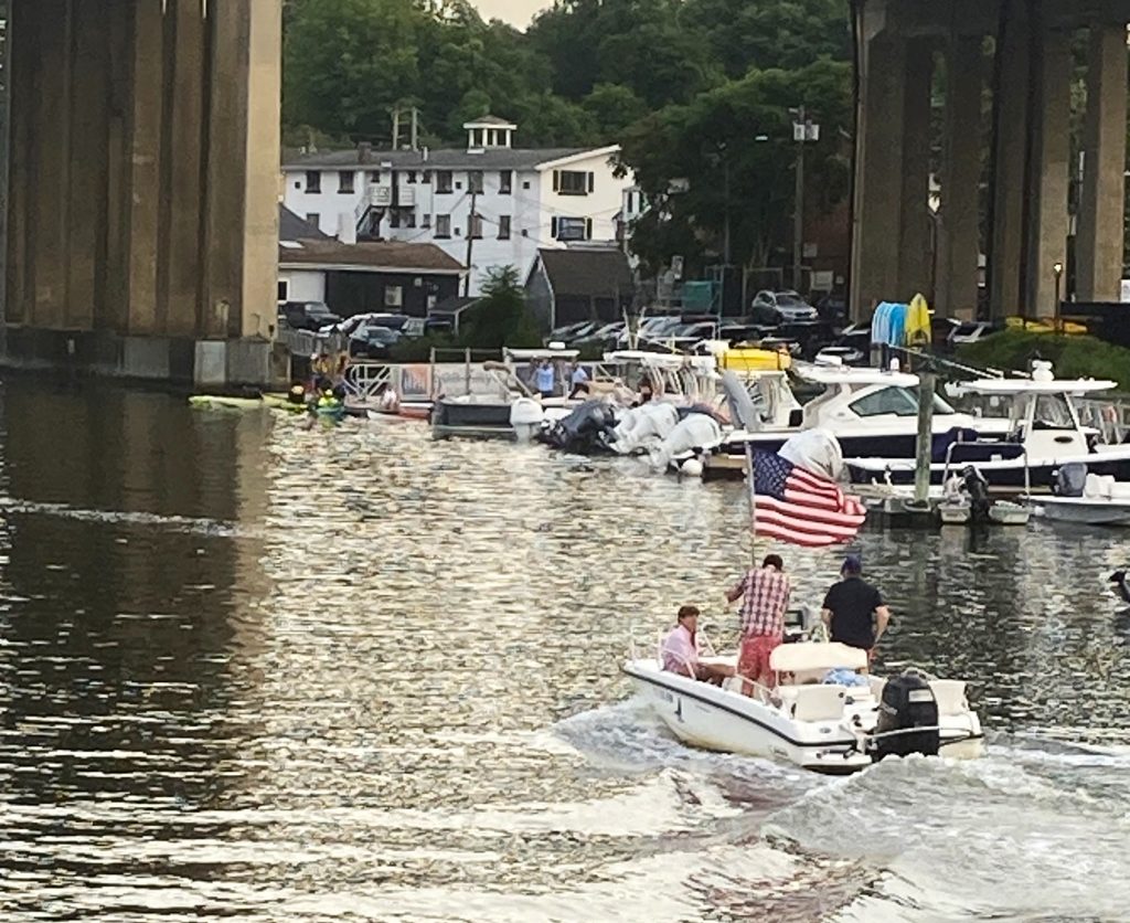 Patriotic boaters head to the Compo shore Tuesday evening.