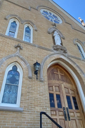 Church of the Assumption's brick facade.