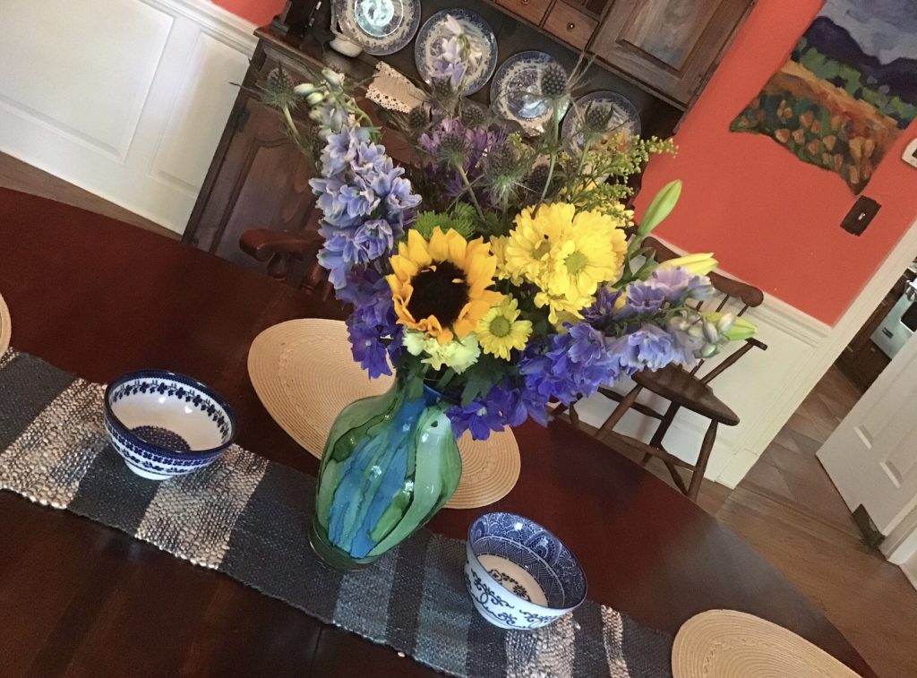 A blue-and-yellow table arrangement by Kerri placed on a hand-woven runner - Photo Kerri Williams
