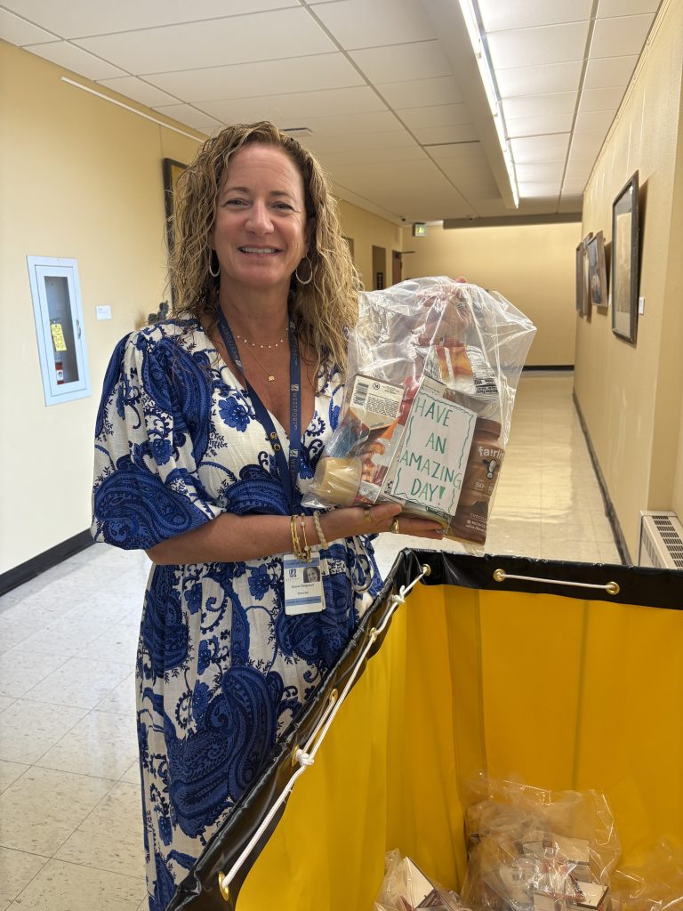 Elaine Daignault, director of the Westport Human Services Department, holds a bag of food items distributed to children in the summer through the “Filling in the Blanks” program.