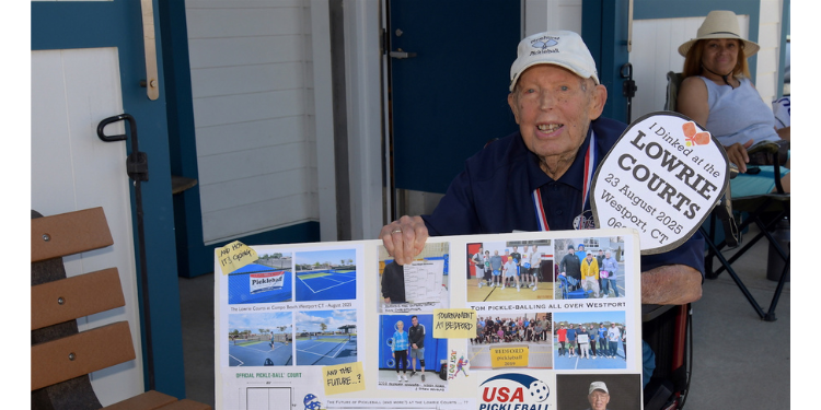 Lowrie with plans & memorabilia of the build project