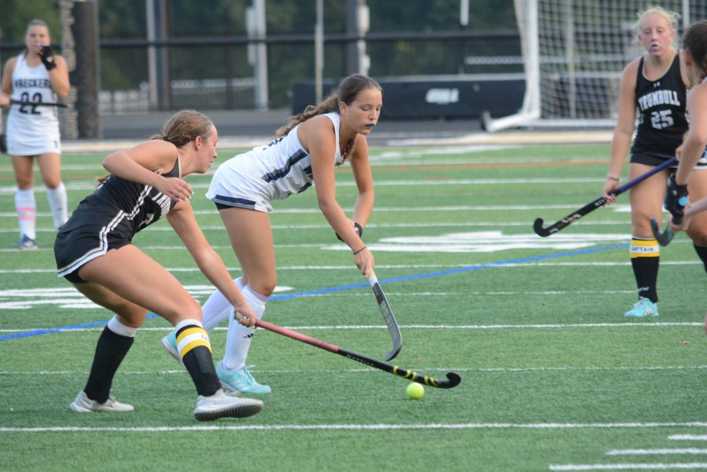 Olivia Lambert, right, battles a Trumbull player for the ball - Photo Andy Hutchison