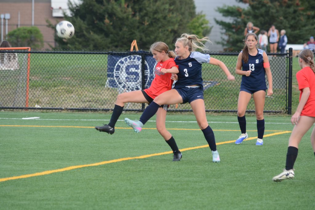 Meave Mulvey (No. 3) controls the ball as teammate Sadie Katzner (No. 13) and a Pomperaug player join the play during a preseason scrimmage - Photo Andy Hutchison