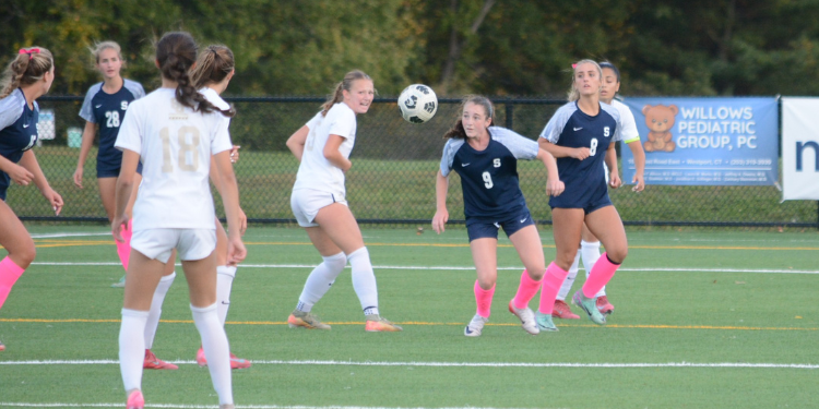 Alexa Van Aken (No. 9) moves the ball as Reece Dearborn (No. 8) stands in position during a game this fall - Photo Andy Hutchison