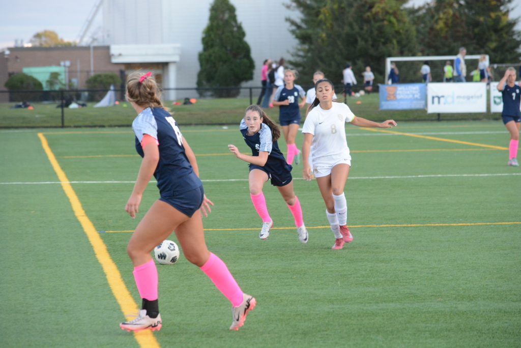 Alexa Van Aken, running after the ball in a game this fall, had a goal and an assist in the state playoff opener - Photo Andy Hutchison