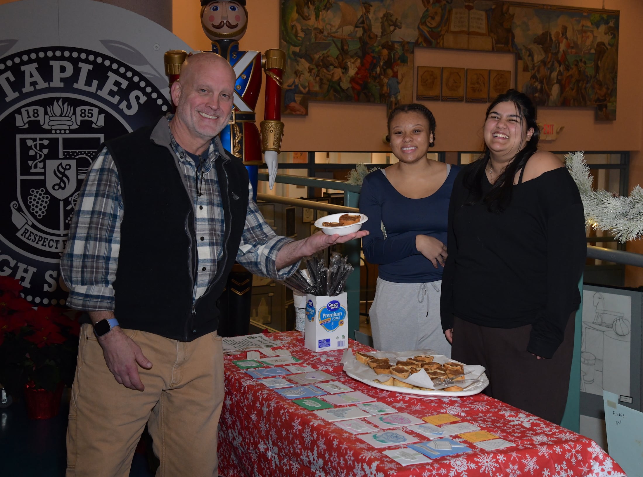Staples Garden Club’s Brynn Livingston Vani Punia sell their baked goods to Rich Stein of Westport