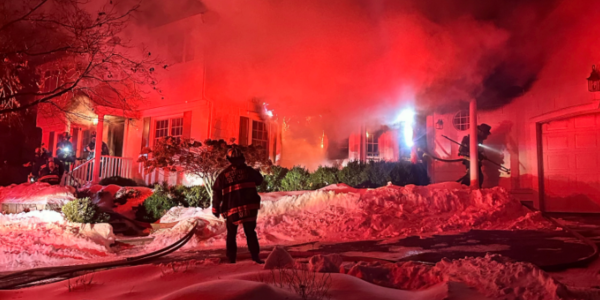Smoke mixes with steam as fire is doused