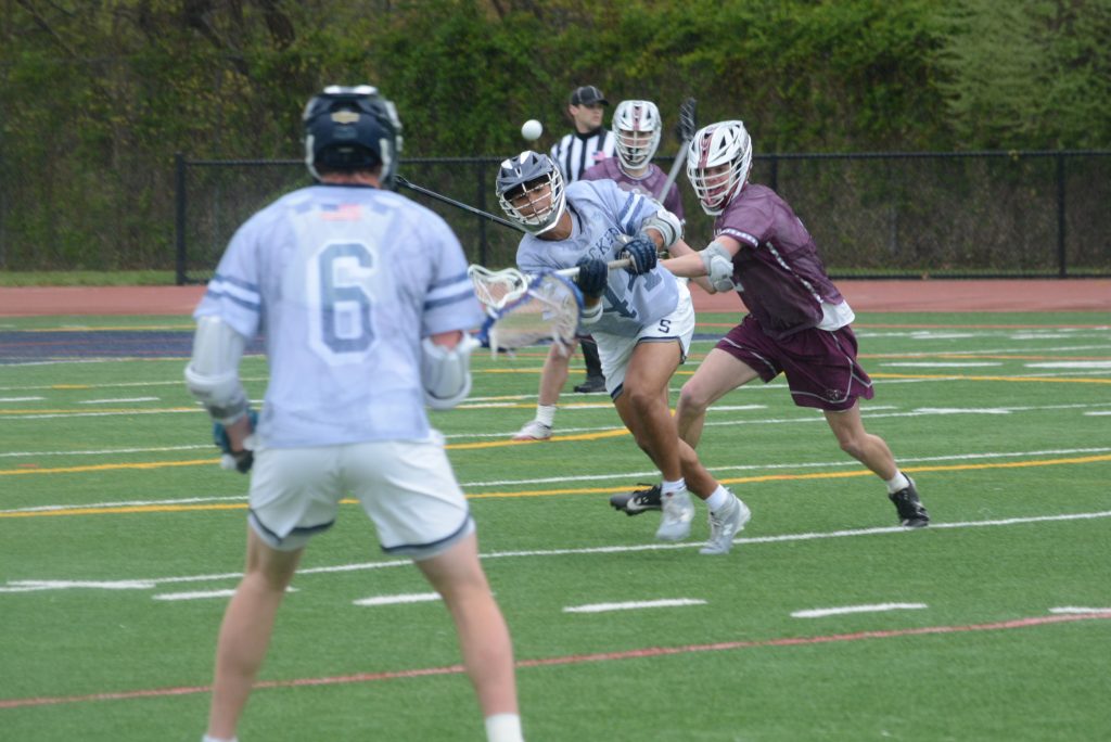 Max Hill passes to Ean Frankel (No. 6) while under pressure