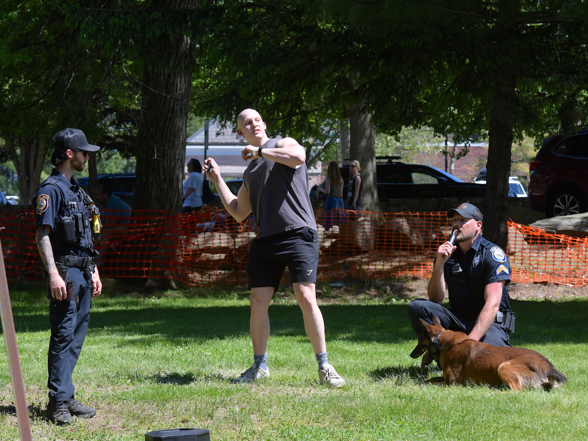 Josh Sachakov, Fairfield, throws his car keys onto lawn, for K9 Ambo to find