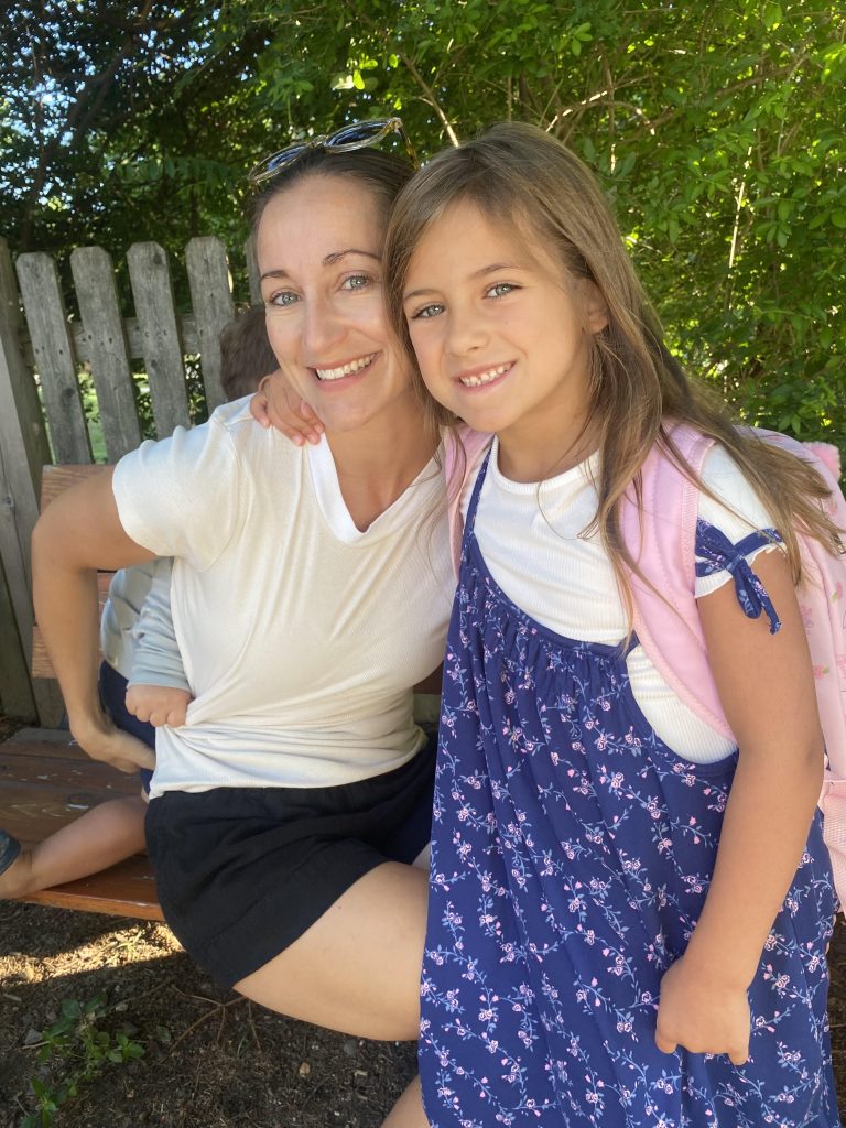 Student Emma Vodola waiting for the bus to Saugatuck Elementary School on Imperial Avenue, with Lee Evans